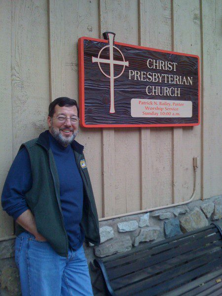 Pastor Pat Bailey in front his church