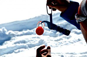 Examining the core sample of snow.