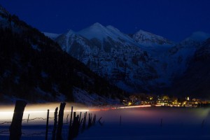 Telluride shines at night against a mountain backdrop, by Ryan Bonneau