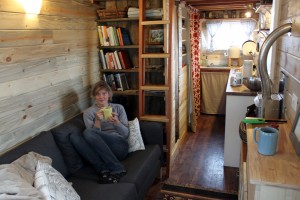 Merete on the couch in the "Tiny" house