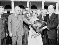 Photograph of President Truman receiving a Thanksgiving turkey from members of the Poultry and Egg National Board and other representatives of the turkey industry, outside the White House., 11/16/1949 Harry S. Truman Library [National Archives Identifier 200138]