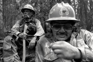 Two Bureau of Indian Affairs firefighters take a break in a blackened aspen grove during the Burn Canyon Fire near Norwood, Colorado, Ben Knight