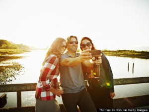 Three friends taking self portrait with smartphone, from Huff Post Healthy Living.