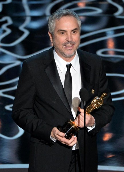 Alfronso Curaon accepts Best Director at Oscars. By Kevin Winter:Getty Images.