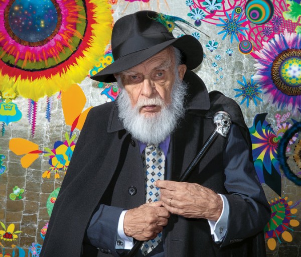 James Randi in front of a painting done by his partner, the artist José Alvarez. Credit Jeff Minton for The New York Times