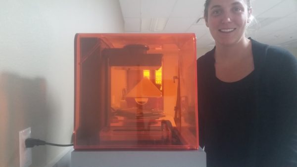 Pinhead’s program manager Claire Carver with Formlab’s 3D desktop printer.