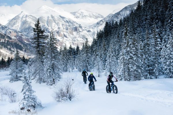 biking on valley floor with bkgrd scenery